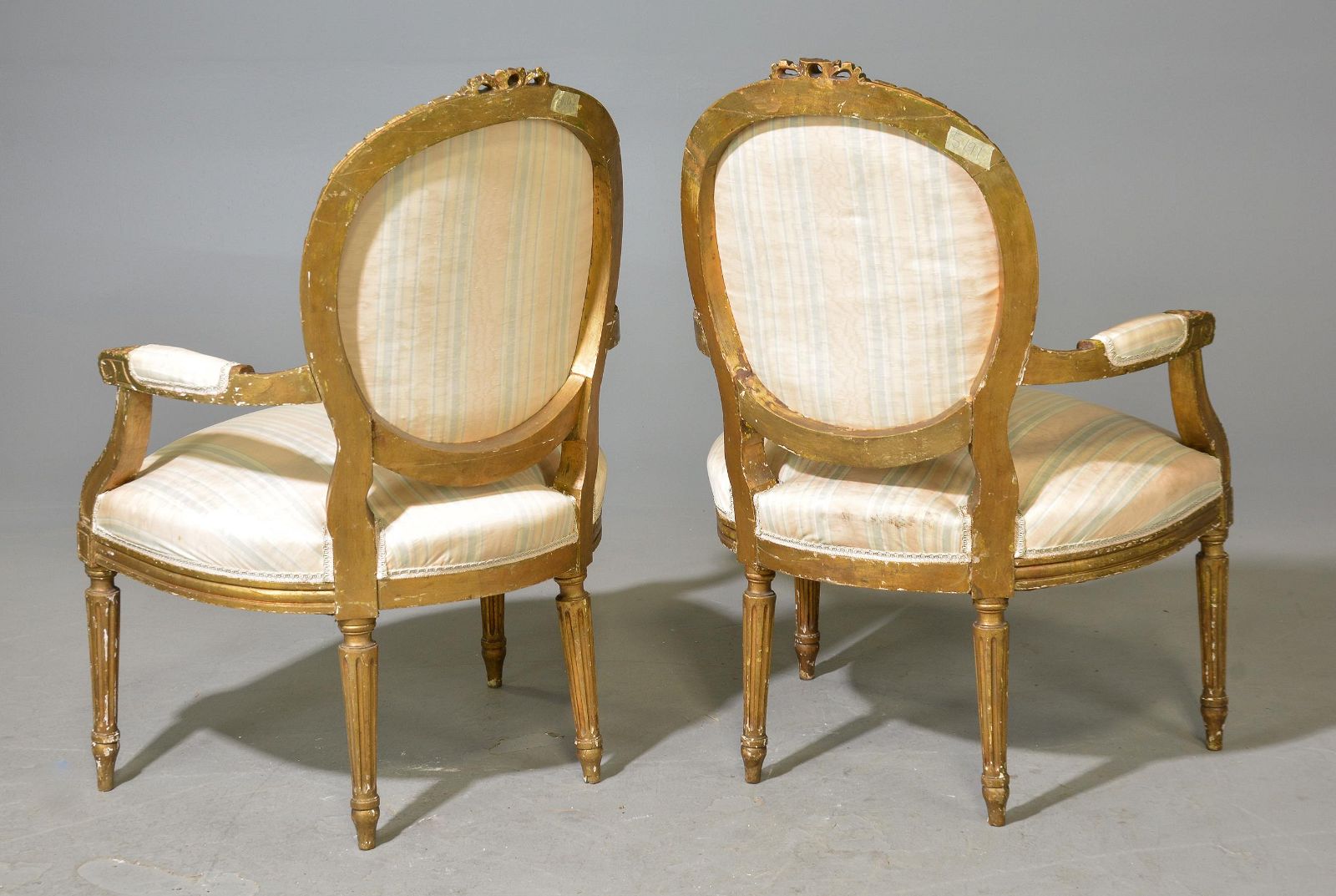 Pair of Louis XVI gilded armchairs with cane seat and back